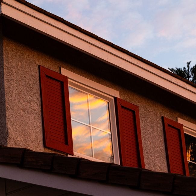 Exterior window frames and eaves painted in crisp white