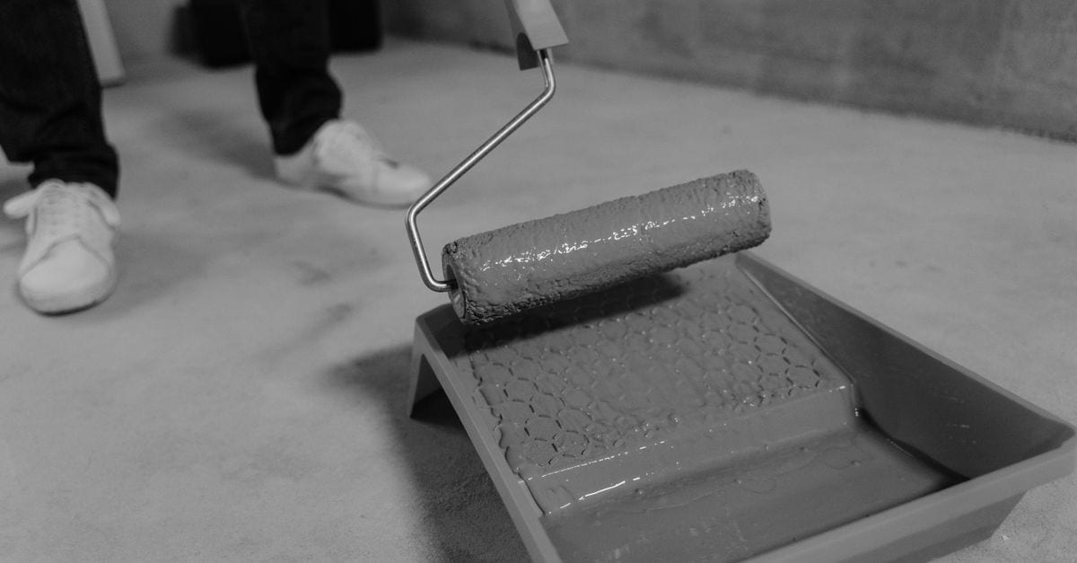 A concrete driveway part way through a coat