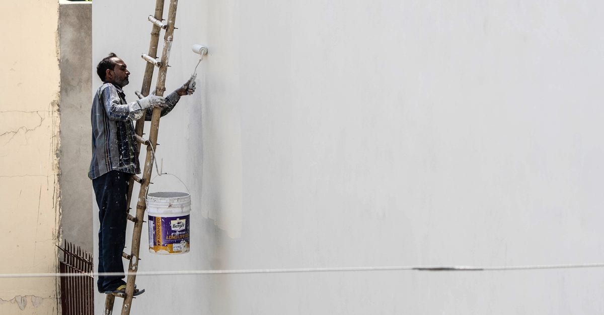 A painter working on a house exterior