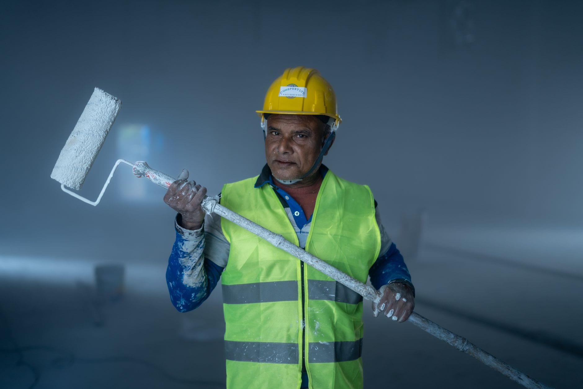 Commercial painting tools and equipment laid out on a job site