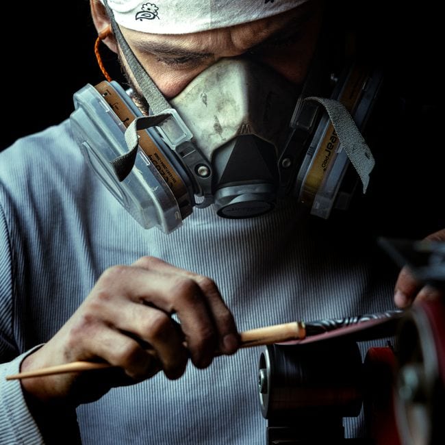 Painter cutting in ceiling line with precision brush